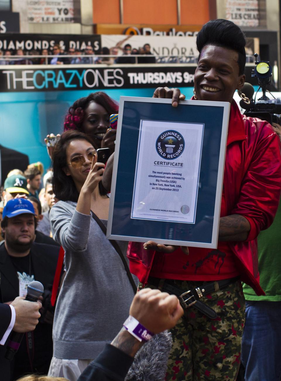 American musician Big Freedia holds a certificate from the Guinness World Record after 358 people twerked at once in New York. (Reuters)