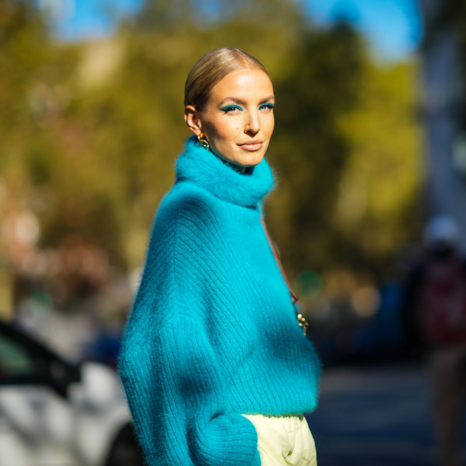 woman in blue turtleneck designer sweater 