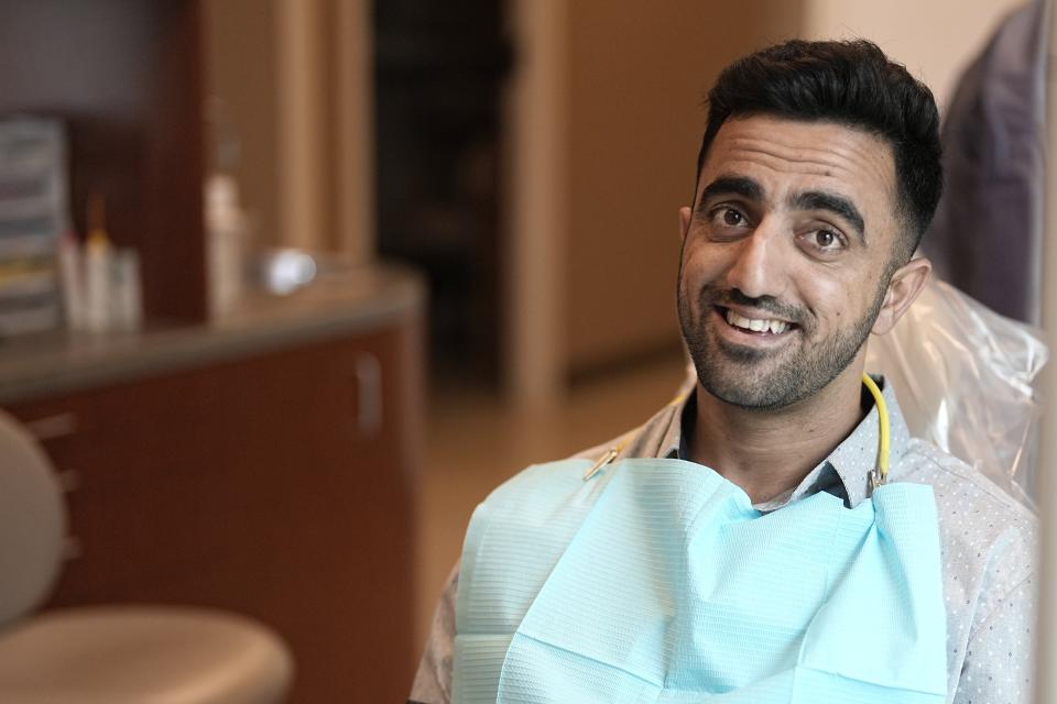 Abdul Wasi Safi waits for the start of his dental appointment during a clinic visit, Wednesday, April 26, 2023, in Houston. Safi's days since his release from a Texas immigration detention center have been filled with medical appointments while living in Houston with his brother. (AP Photo/David J. Phillip)