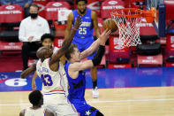 Orlando Magic's Moritz Wagner, right, goes up for a shot against Philadelphia 76ers' Anthony Tolliver during the second half of an NBA basketball game, Sunday, May 16, 2021, in Philadelphia. (AP Photo/Matt Slocum)