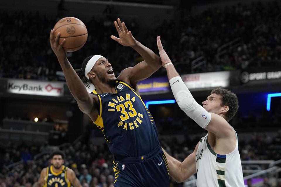 Indiana Pacers' Myles Turner shoots over Milwaukee Bucks' Brook Lopez (11) during the first half of an NBA basketball game, Wednesday, Jan. 3, 2024, in Indianapolis. (AP Photo/Darron Cummings)