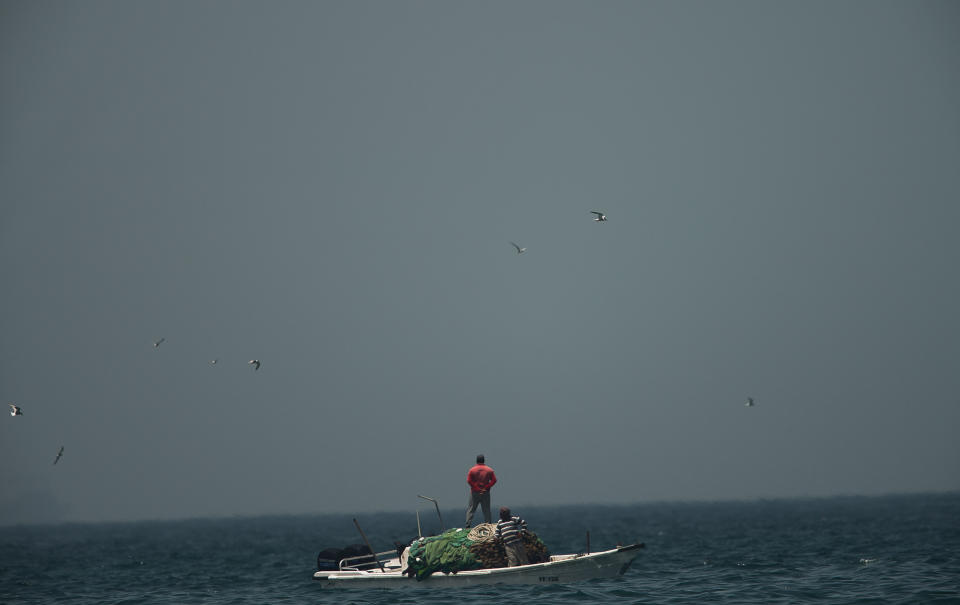 A fishing boat sails in waters off the coast of Fujairah, United Arab Emirates, Monday, May 13, 2019. Saudi Arabia said Monday two of its oil tankers were sabotaged off the coast of the United Arab Emirates near Fujairah in attacks that caused "significant damage" to the vessels, one of them as it was en route to pick up Saudi oil to take to the United States. (AP Photo/Jon Gambrell)
