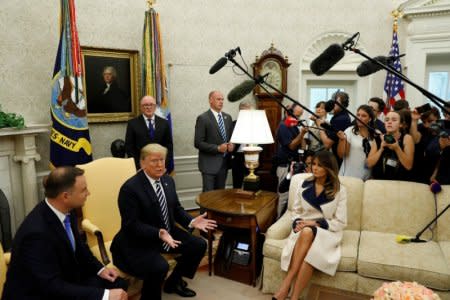 U.S. President Donald Trump speaks next to first lady Melania Trump during a meeting with Poland's President Andrzej Duda (L) in the Oval Office of the White House in Washington, U.S., September 18, 2018. REUTERS/Kevin Lamarque