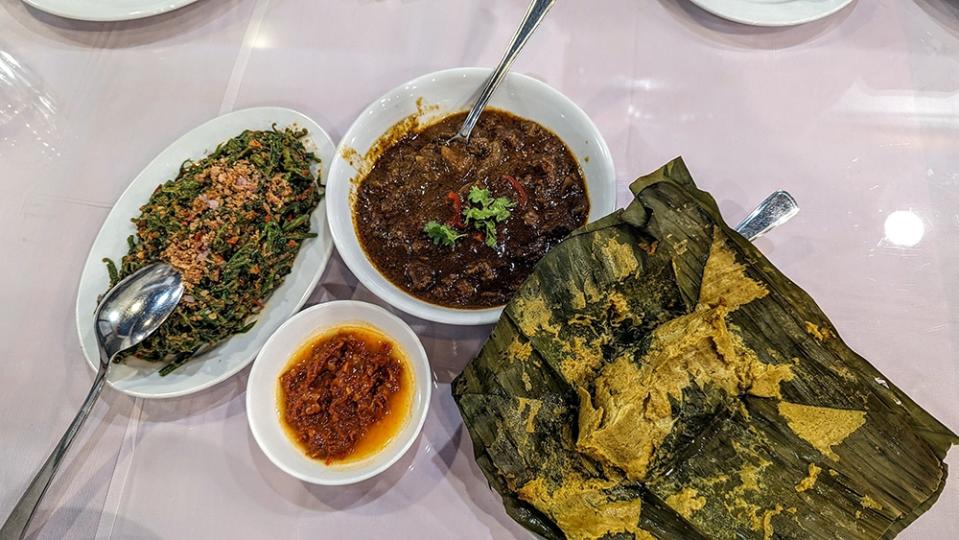 From the left: 'kerabu lemak sayur paku', beef tendon 'rendang', otak-otak and some killer 'sambal belacan' at the bottom.