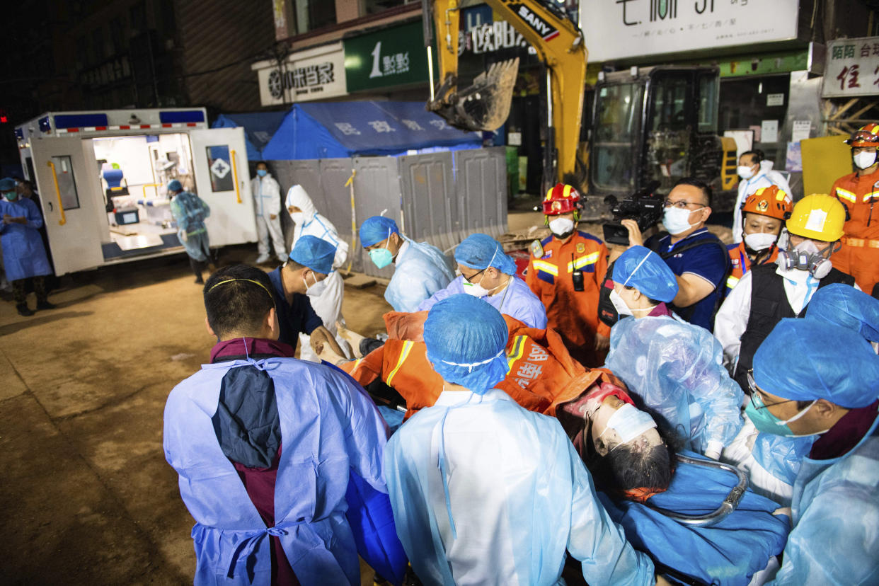 In this photo released by Xinhua News Agency, medical workers evacuate the 10th survivor pulled alive after being trapped 132 hours from the debris of a self-built residential structure that collapsed in Changsha in central China's Hunan Province on Thursday May 5, 2022. Rescuers in central China have pulled the woman alive from the rubble of a building that partially collapsed almost six days earlier, state media reported Thursday. (Chen Sihan/Xinhua via AP)