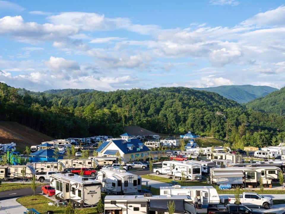 RVs parked at a Camp Magaritaville among mountains.