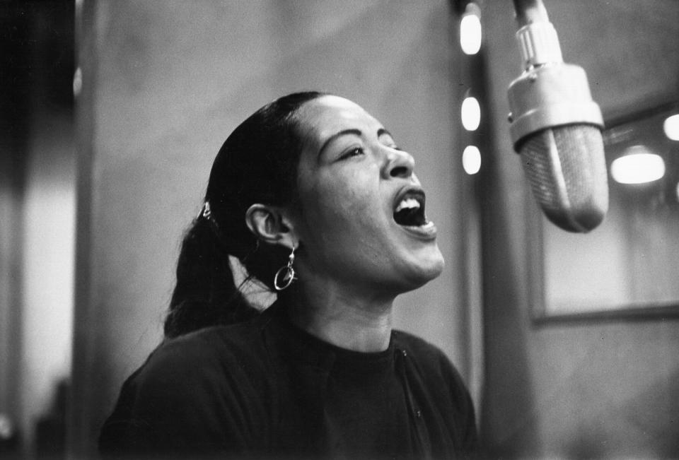 Singer Billie Holiday records her penultimate album at the Columbia Records studio in New York in Dec. 1957.<span class="copyright">Michael Ochs Archives—Getty Images</span>