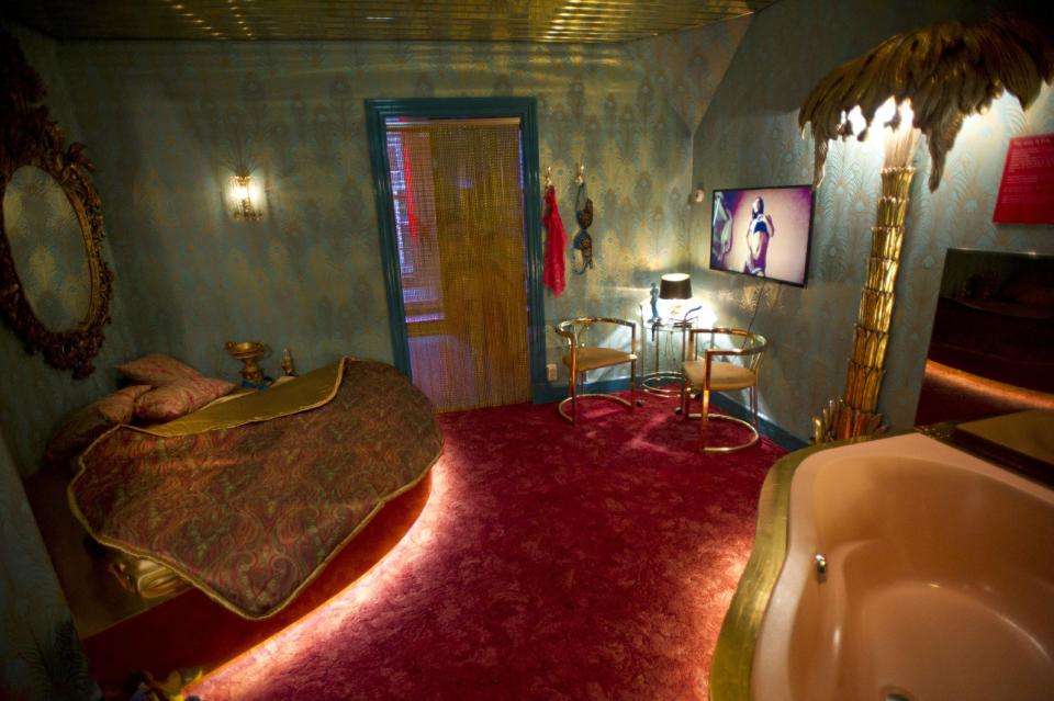 In this photo taken Tuesday, Feb. 4, 2014, a mock up of a luxury suite in a brothel is seen at the 'Red Light Secrets' museum in Amsterdam. On any given evening, thousands of tourists stroll down the narrow streets of Amsterdam's famed Red Light District, gawking at ladies in lingerie who work behind windows, making a living selling sex for money. Now a small educational museum is opening in heart of the district that aims to show reality from the other side of the glass. Organizer Melcher de Wind says the Red Light Secrets museum is for those who want to learn more about how the area works without actually visiting a prostitute. (AP Photo/Evert Elzinga)