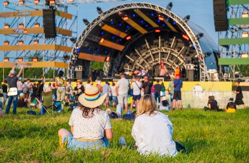 <span class="caption">Profit margins on smaller music festivals can be tiny.</span> <span class="attribution"><a class="link " href="https://www.shutterstock.com/image-photo/rear-view-two-friends-sitting-on-2413881855" rel="nofollow noopener" target="_blank" data-ylk="slk:Anton Gvozdikov/Shutterstock;elm:context_link;itc:0;sec:content-canvas">Anton Gvozdikov/Shutterstock</a></span>
