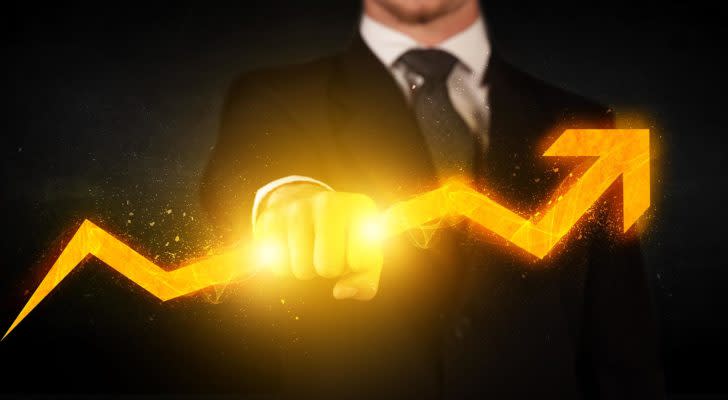 Image of businessman holding a fiery arrow that's heading in an upward trajectory