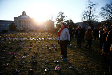 Activists install 7000 shoes on the lawn in front of the U.S. Capitol on Capitol Hill in Washington, U.S. March 13, 2018. REUTERS/Eric Thayer