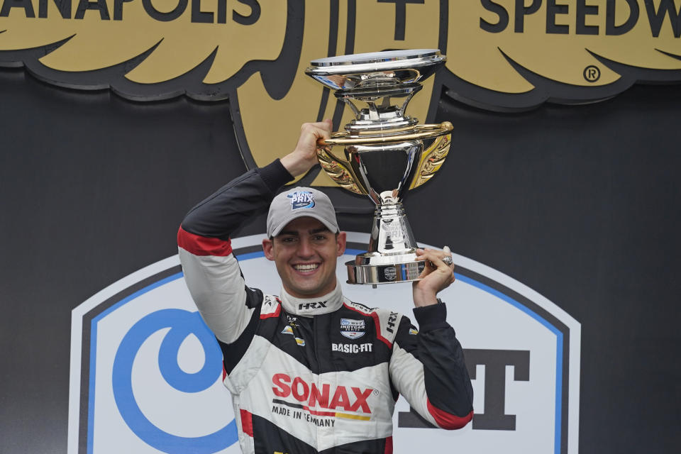 Rinus VeeKay, of the Netherlands, holds the trophy after winning the IndyCar auto race at Indianapolis Motor Speedway, Saturday, May 15, 2021, in Indianapolis. (AP Photo/Darron Cummings)