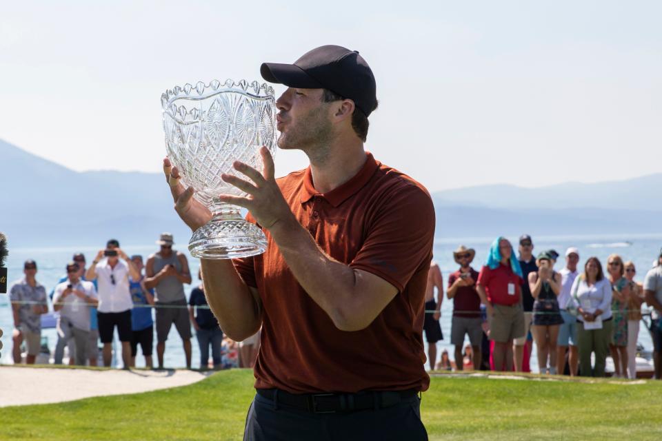 Tony Romo kisses the championship trophy after the final round of the American Century Celebrity Championship golf tournament at Edgewood Tahoe Golf Course in Stateline, Nev., Sunday, July 10, 2022. (AP Photo/Tom R. Smedes)