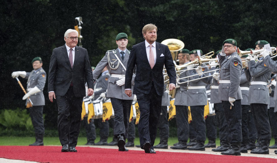 German president Frank-Walter Steinmeier, left, welcomes King Willem-Alexander of the Netherlands with military honours at the Bellevue palace in Berlin, Germany, Monday, July 5, 2021. The Royals arrived in Germany for a three-day visit that was delayed from last year because of the coronavirus pandemic. (Bernd Von Jutrczenka/dpa via AP)