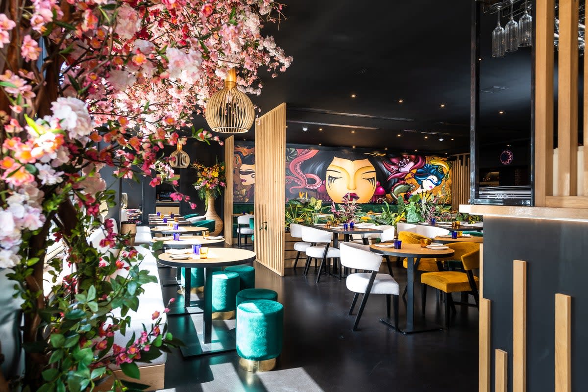 The interior at Nakanojo, featuring an explosion of faux cherry blossoms and a bold mural (Nakanojo)