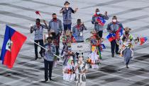 <p>Haiti's flag bearer Darrelle Valsaint Jr leads the delegation during the opening ceremony of the Tokyo 2020 Olympic Games, at the Olympic Stadium, in Tokyo, on July 23, 2021. (Photo by Martin BUREAU / AFP) (Photo by MARTIN BUREAU/AFP via Getty Images)</p> 