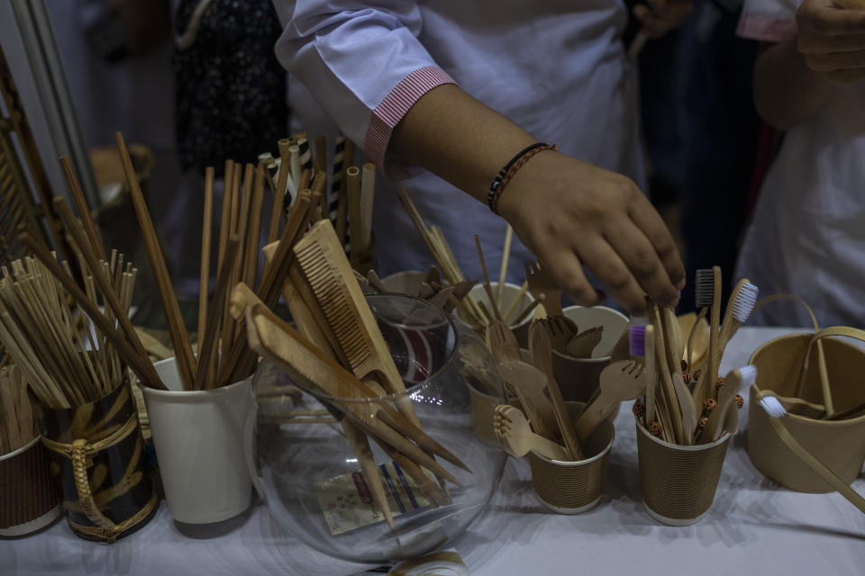 A schoolgirl looks at items which are an alternate to plastic at an event to create awareness about eco-friendly products in New Delhi, India, Friday, July 1, 2022. India banned some single-use or disposable plastic products Friday as part of a federal plan to phase out the ubiquitous material in the nation of nearly 1.4 billion people. (AP Photo/Altaf Qadri)