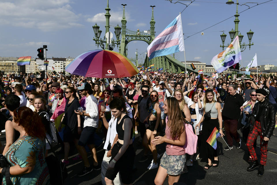 People march across the Szabadsag, or Freedom Bridge over the River Danube in downtown Budapest during a gay pride parade in Budapest, Hungary, Saturday, July 24, 2021. Rising anger over policies of Hungary's right-wing government filled the streets of the country's capital on Saturday as thousands of LGBT activists and supporters marched in the city's Pride parade. (AP Photo/Anna Szilagyi)