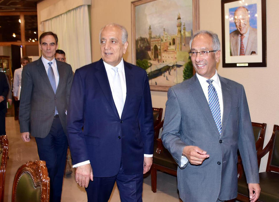 In this photo released by the Foreign Office, Pakistan's Foreign Ministry official Aftab Khokhar, right, escorts visiting Special Representative for Afghanistan Reconciliation Zalmay Khalilzad, center, for talks at the Foreign Office in Islamabad, Pakistan, Sunday, June 2, 2019. Khalilzad has met Pakistani officials to find a peaceful solution to neighboring Afghanistan's war. (Pakistan Foreign Office via AP)