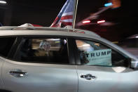 Supporters of President Donald Trump drive past the entrance to Walter Reed National Military Medical Center in Bethesda, Md., Sunday, Oct. 4, 2020. Trump was admitted to the hospital after contracting the coronavirus. (AP Photo/Cliff Owen)