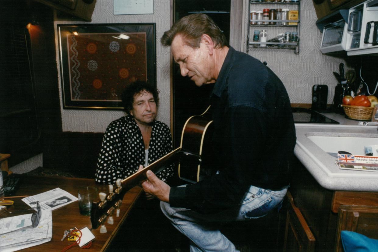 Bob Dylan listens to Sun Records great Billy Lee Riley play on his tour bus in 1992.