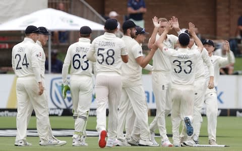 Stuart Broad high fives his team-mates - Credit: RICHARD HUGGARD/AFP via Getty Images