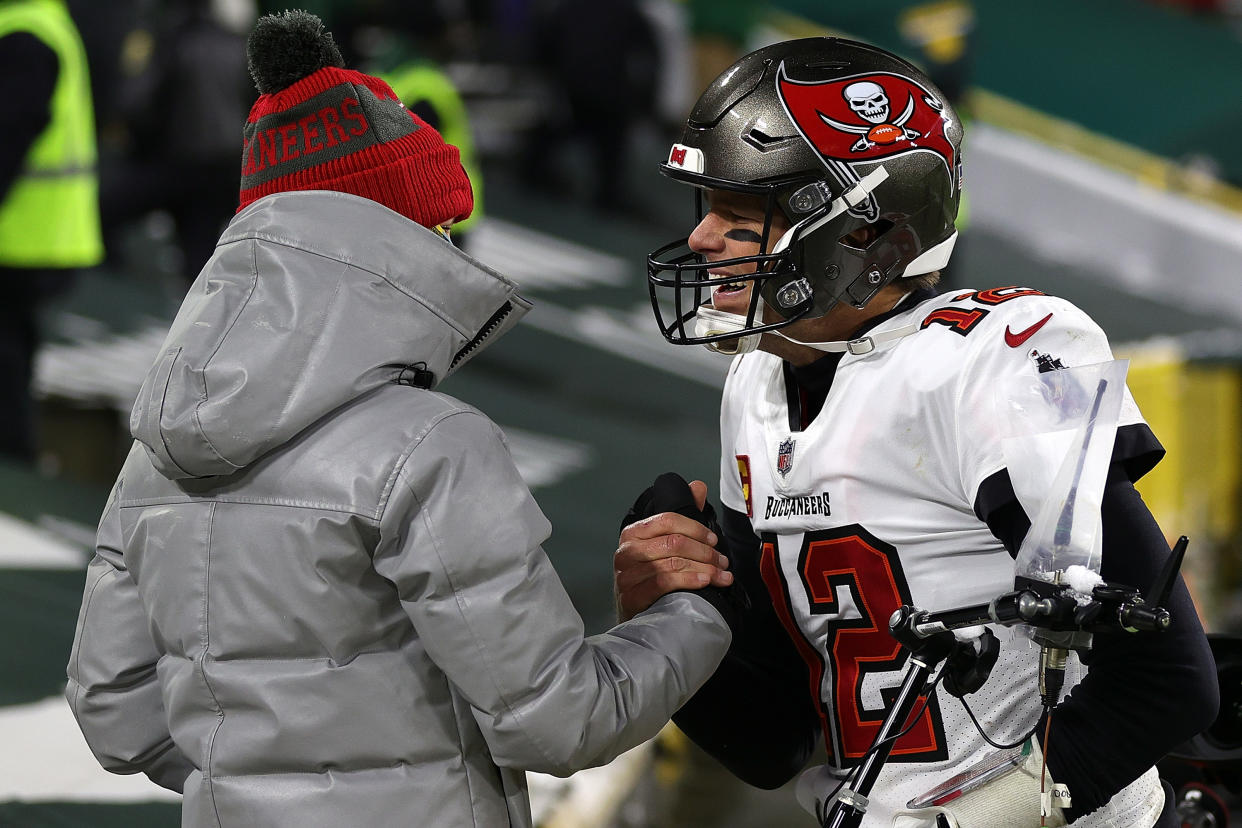 Tom Brady of the Tampa Bay Buccaneers greets his son Jack following their victory over the Green Bay Packers. (Photo by Stacy Revere/Getty Images)