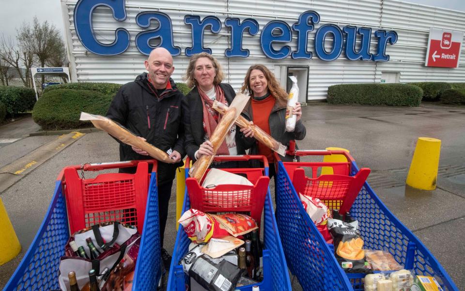 Tracey, centre, with her friends Ben and Nicola, outside Carrefour in Calais.