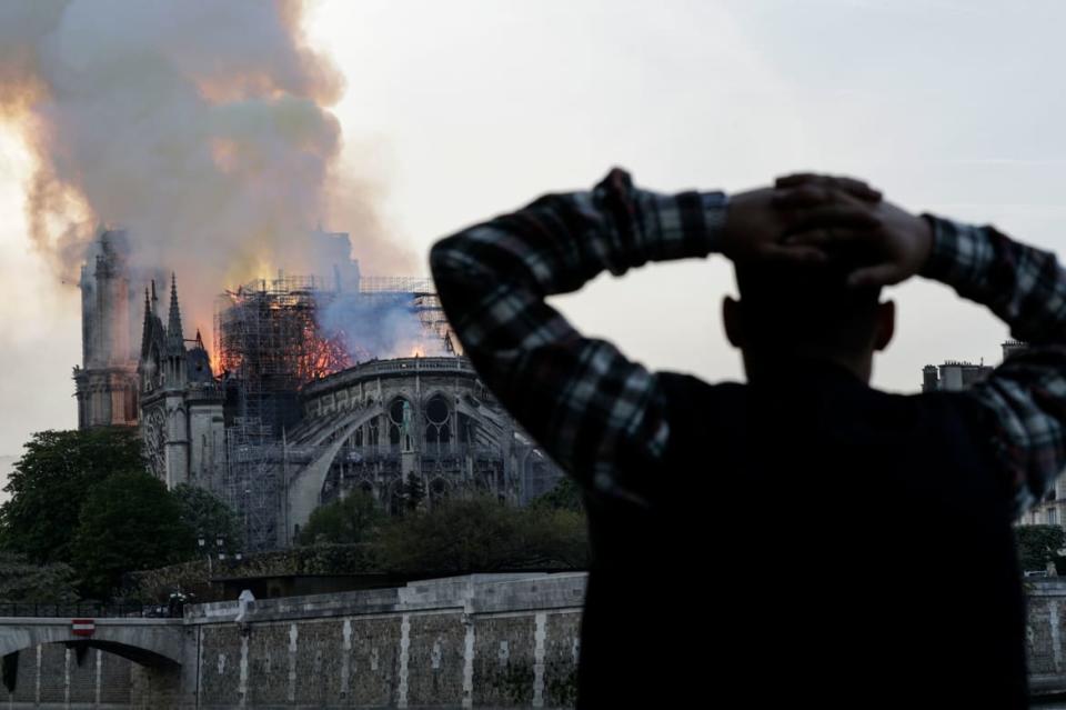 <div class="inline-image__caption"><p>A man watches the landmark Notre-Dame Cathedral burn, engulfed in flames, in central Paris on April 15, 2019. A huge fire swept through the roof of the famed Notre-Dame Cathedral in central Paris on April 15, 2019, sending flames and huge clouds of grey smoke billowing into the sky. The flames and smoke plumed from the spire and roof of the gothic cathedral, visited by millions of people a year. A spokesman for the cathedral told AFP that the wooden structure supporting the roof was being gutted by the blaze. </p></div> <div class="inline-image__credit">Geoffroy Van Der Hasselt/Getty</div>