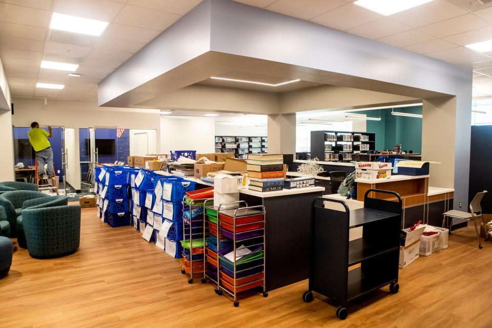 Workers prepare the library of the Everett Meredith Middle School in Middletown.