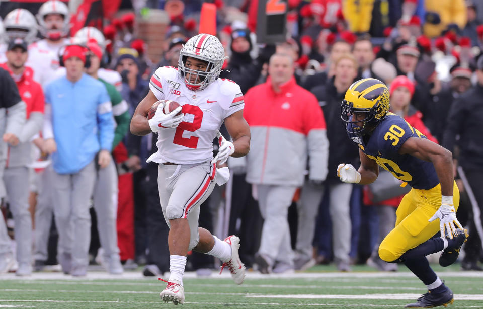 Ohio State running back J.K. Dobbins (2) darts past Michigan's Daxton Hill during the first quarter on Saturday. (Leon Halip/Getty Images)
