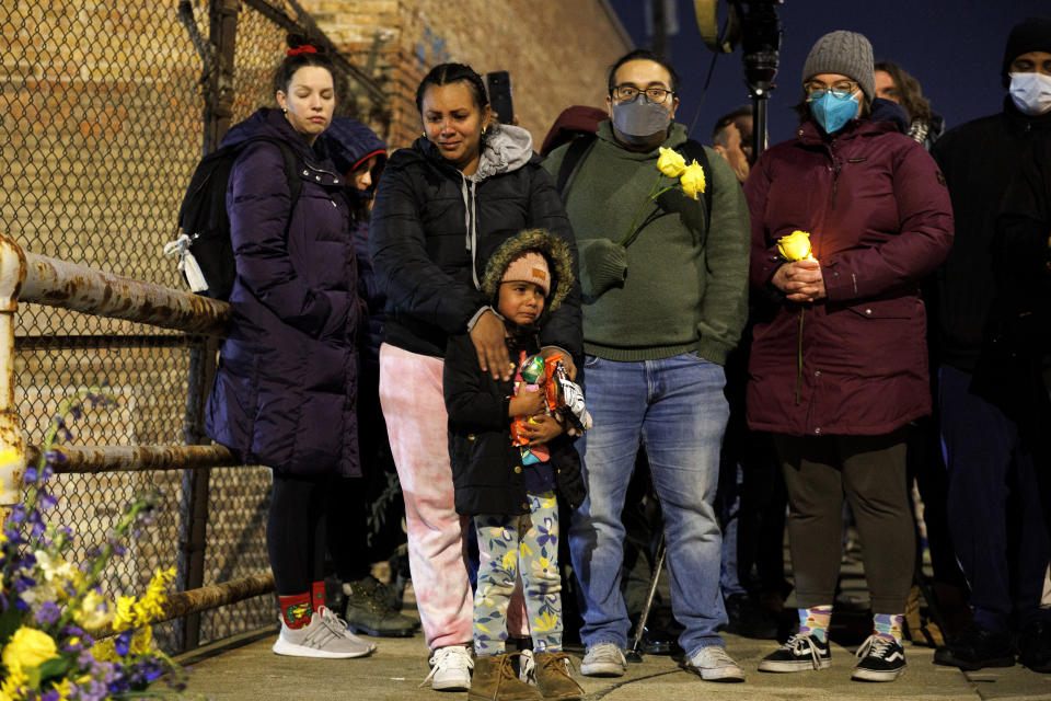 A woman and child cry while attending a vigil for 5-year-old Jean Carlos Martinez Rivero, who died over the weekend at the Lower West Side shelter, Wednesday, Dec. 20, 2023, in Chicago. Thousands of migrants have come to Chicago over the past 16 months, and over 2,000 migrants are housed at the shelter. (Armando L. Sanchez/Chicago Tribune via AP)