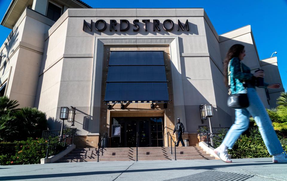 A security guard patrols the front entrance of Nordstrom on Tuesday after an organized group of thieves attempted a smash-and-grab robbery late Monday night at The Grove location November 23, 20201 in Los Angeles, California.