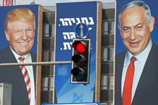 An Israeli election banner bears the portraits of US President Donald Trump (L) and Prime Minister Benjamin Netanyahu hanging on a building facade in Jerusalem