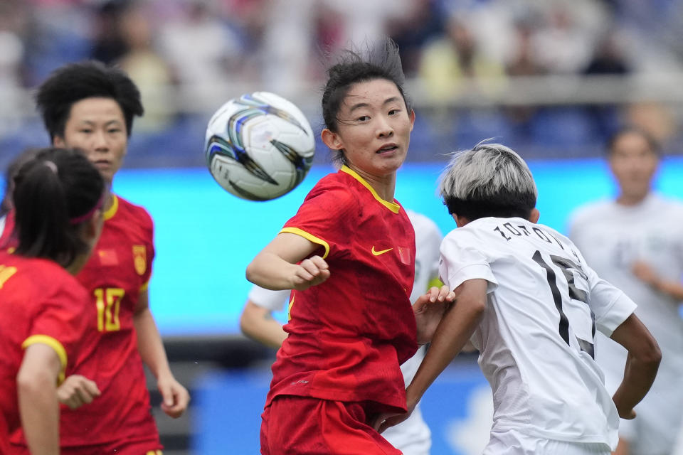 China's Yao Wei, center, battles for the ball against Uzbekistan's Umida Zoirova during their women's soccer bronze medal match at the 19th Asian Games in Hangzhou, China, Friday, Oct. 6, 2023. (AP Photo/Vincent Thian)