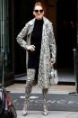 <p>In a snakeskin coat, matching thigh-high boots, and bag while leaving the Hotel Royal Monceau in Paris. </p>