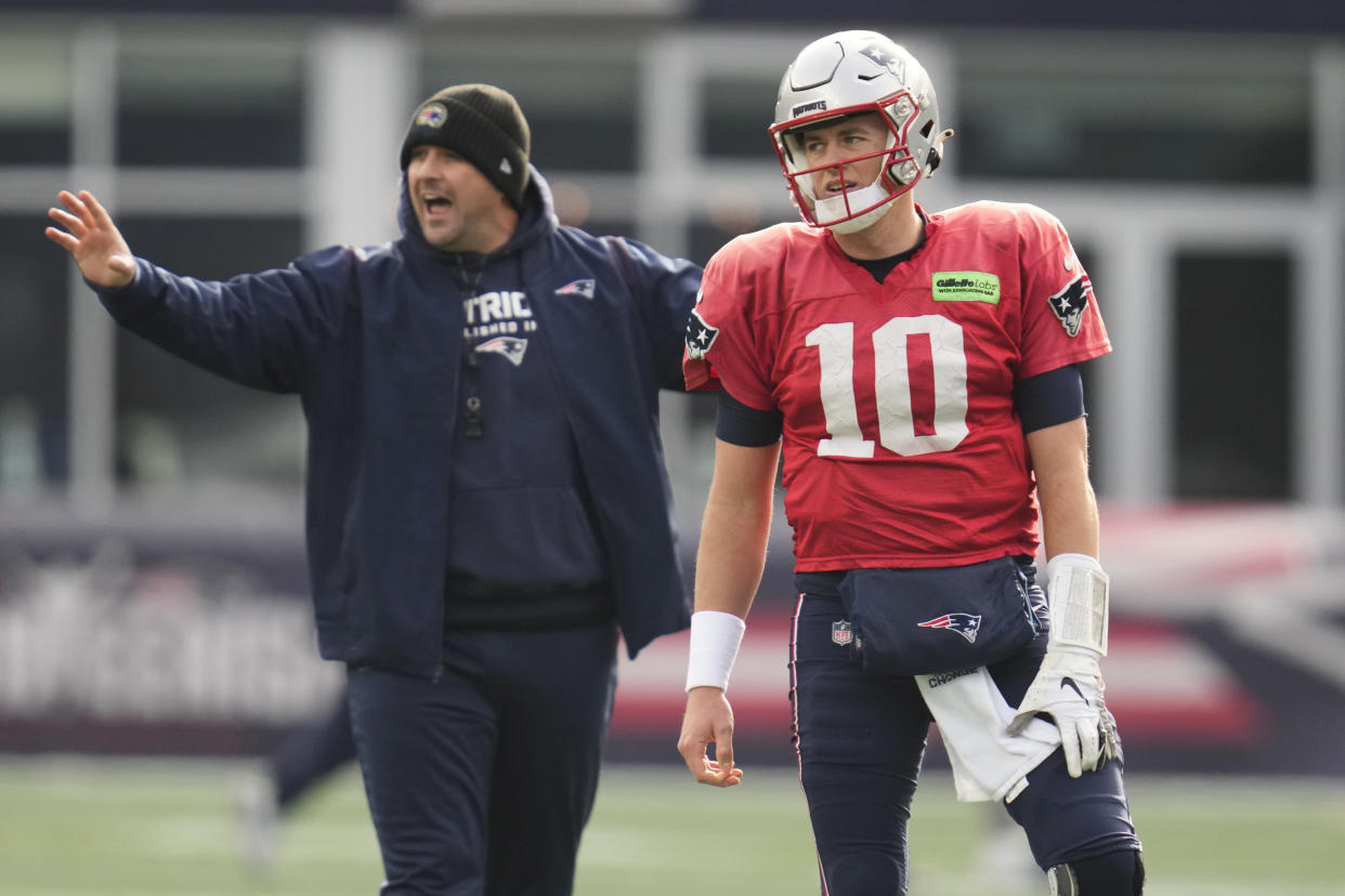 New England Patriots quarterback Mac Jones (10) waits as quarterbacks coach Joe Judge calls to players during football practice, Wednesday, Dec. 28, 2022, in Foxborough, Mass. (AP Photo/Charles Krupa)