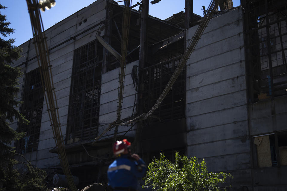 A state emergency service member stands next to debris in a damaged DTEK thermal power plant after a Russian attack in Ukraine, Thursday, May 2, 2024. Ukrainian energy workers are struggling to repair the damage from intensifying airstrikes aimed at pulverizing Ukraine's energy grid, hobbling the economy and sapping the public's morale. (AP Photo/Francisco Seco)