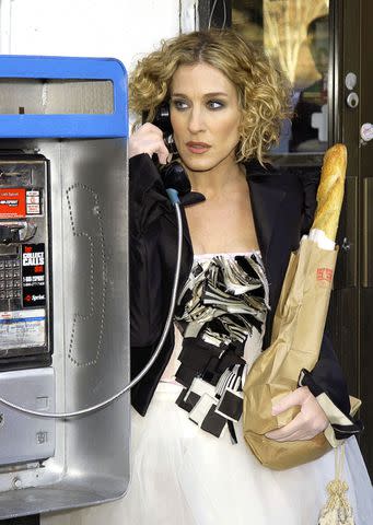 <p>Getty Images</p> Carrie Bradshaw with an actual baguette on 'Sex and the City'