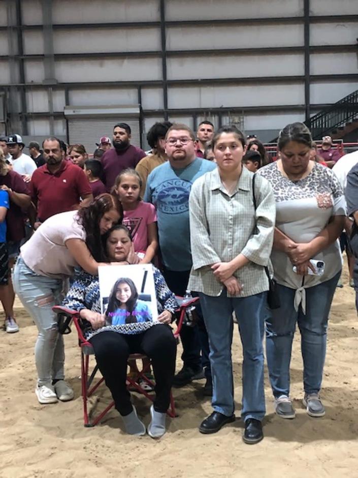 Loved ones of victim Naveah Bravo, who was killed on Tuesday, hold her picture as they gather with leaders and members of the community on Wednesday to commemorate the victims (Sheila Flynn)