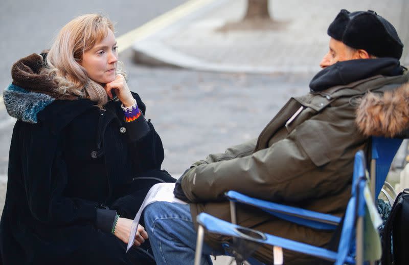 Model Lily Cole listens to a hunger striker outside Conservative Campaign Headquarters in London