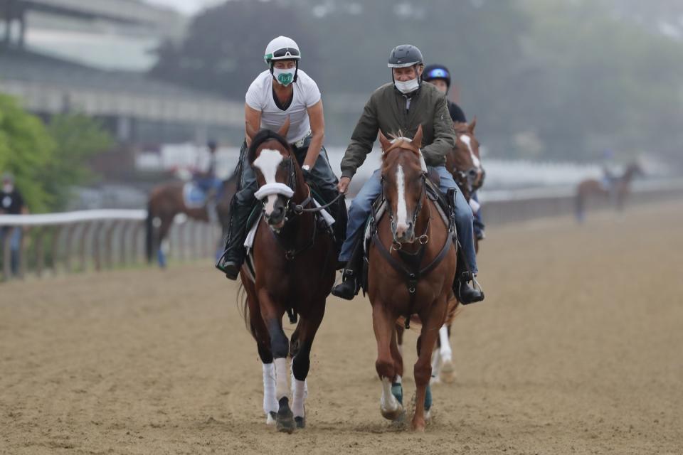 Robin Smullen on Tiz the Law, left, is led around the track by trainer Barclay Tagg in a workout at Belmont Park.