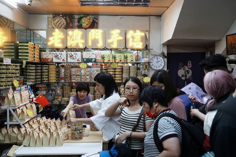 Customers queue up for the bill at the Feng Cheng Recordacao Macau during Labour Day holiday in Macau
