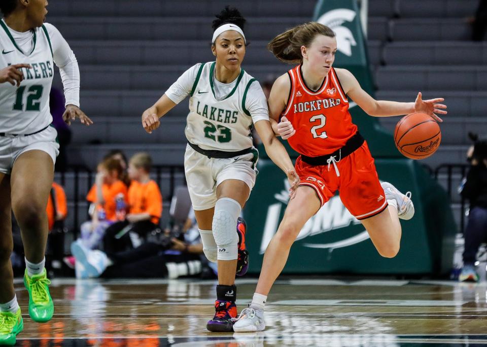 Rockford guard Anna Wypych (2) dribbles against West Bloomfield guard Summer Davis (23) during the first half of the MHSAA Division 1 girls basketball final at Breslin Center in East Lansing on Saturday, March 18, 2023.