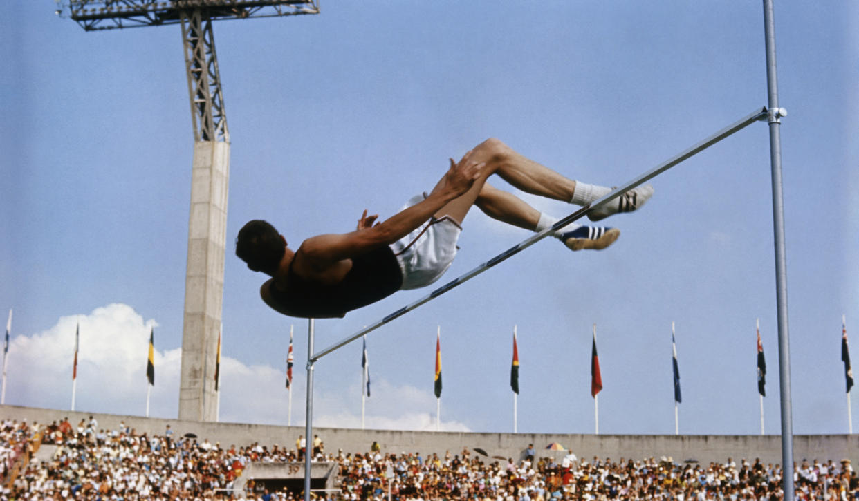 American high jumper Dick Fosbury clears the bar on his third attempt at the 1968 Summer Games in Mexico City. Fosbury won the gold medal with this jump, clearing 7 feet, 4 1/4 inches, which also set Olympic and American records. Dick Fosbury's jumping style, dubbed the 