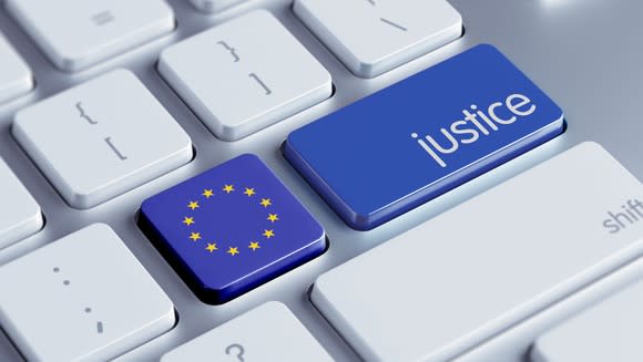 A white computer keyboard with the apostrophe key replaced by the European Union's logo and the Enter key is relabeled as Justice, and these two keys are blue.