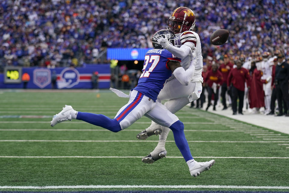 New York Giants safety Jason Pinnock (27) breaks up a pass intended for Washington Commanders wide receiver Jahan Dotson (1) during the fourth quarter of an NFL football game, Sunday, Oct. 22, 2023, in East Rutherford, N.J. (AP Photo/Seth Wenig)