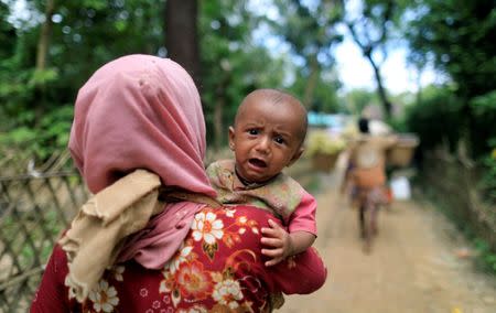 Rohingya refugees, who crossed the border from Myanmar two days earlier, walk after they received permission from the Bangladesh army to continue their way to the Kutupalong refugee camp, in Balukhali near Cox's Bazar, Bangladesh October 19, 2017. REUTERS/ Zohra Bensemra