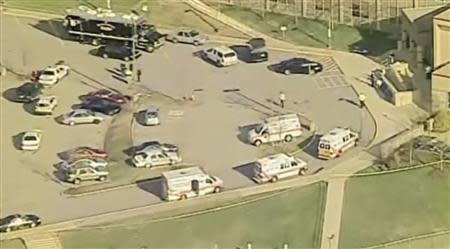 Emergency vehicles are seen in a parking lot outside Franklin Regional High School after reports of stabbing injuries in Murrysville, Pennsylvania April 9, 2014. REUTERS/WPXI/Handout via Reuters