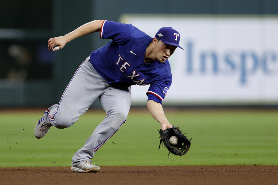 HOUSTON, TEXAS - OCTOBER 23: Corey Seager #5 of the Texas Rangers fields a grounder by Alex Bregman #2 of the Houston Astros during the fifth inning in Game Seven of the American League Championship Series at Minute Maid Park on October 23, 2023 in Houston, Texas. (Photo by Carmen Mandato/Getty Images)